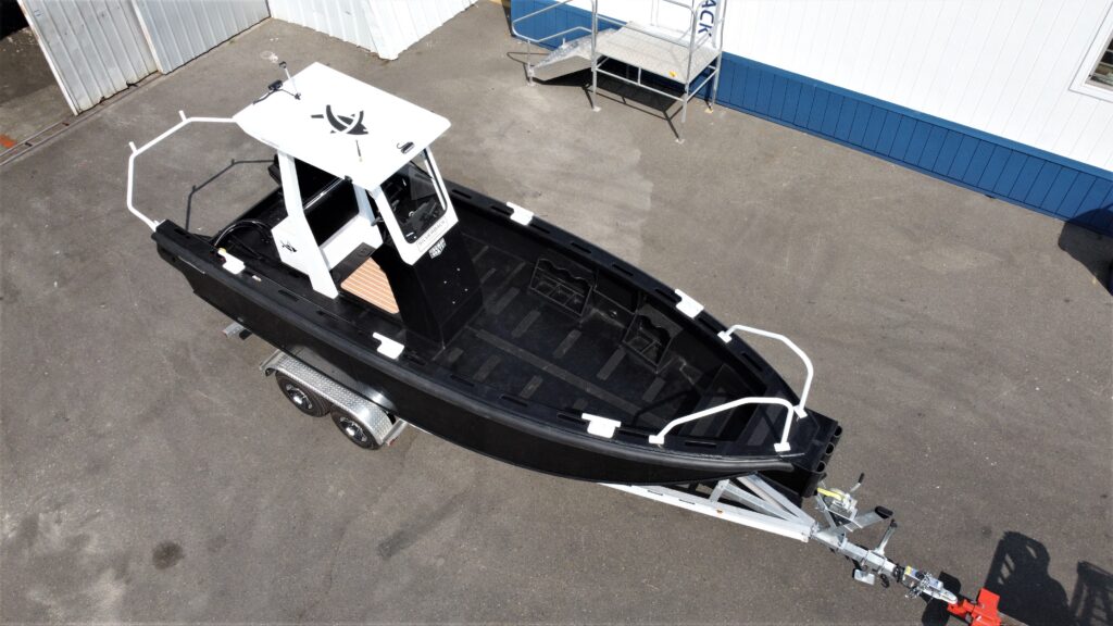 Tideman Marine HDPE hull work boat on a boat trailer in parking lot on pavement