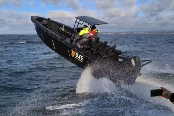 Tideman Marine HDPE hull work boat catching air above a wave in the water