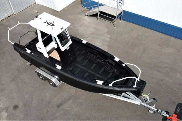 Tideman Marine HDPE hull work boat on boat trailer in a parking lot